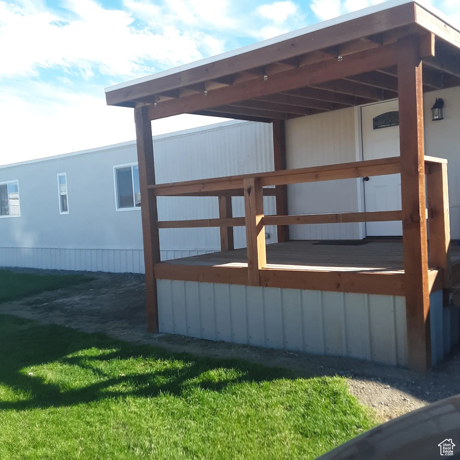 Wooden deck featuring a lawn