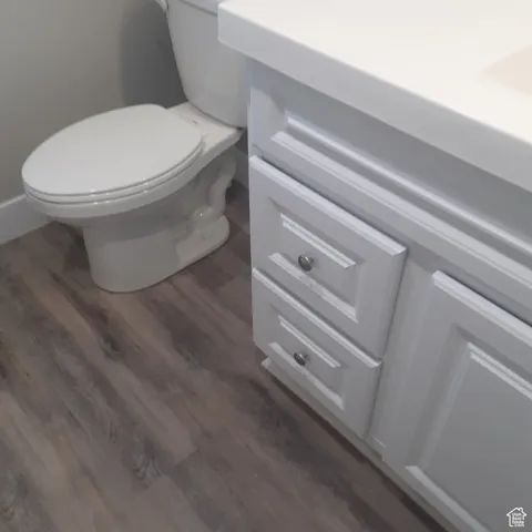Bathroom with toilet and wood finished floors