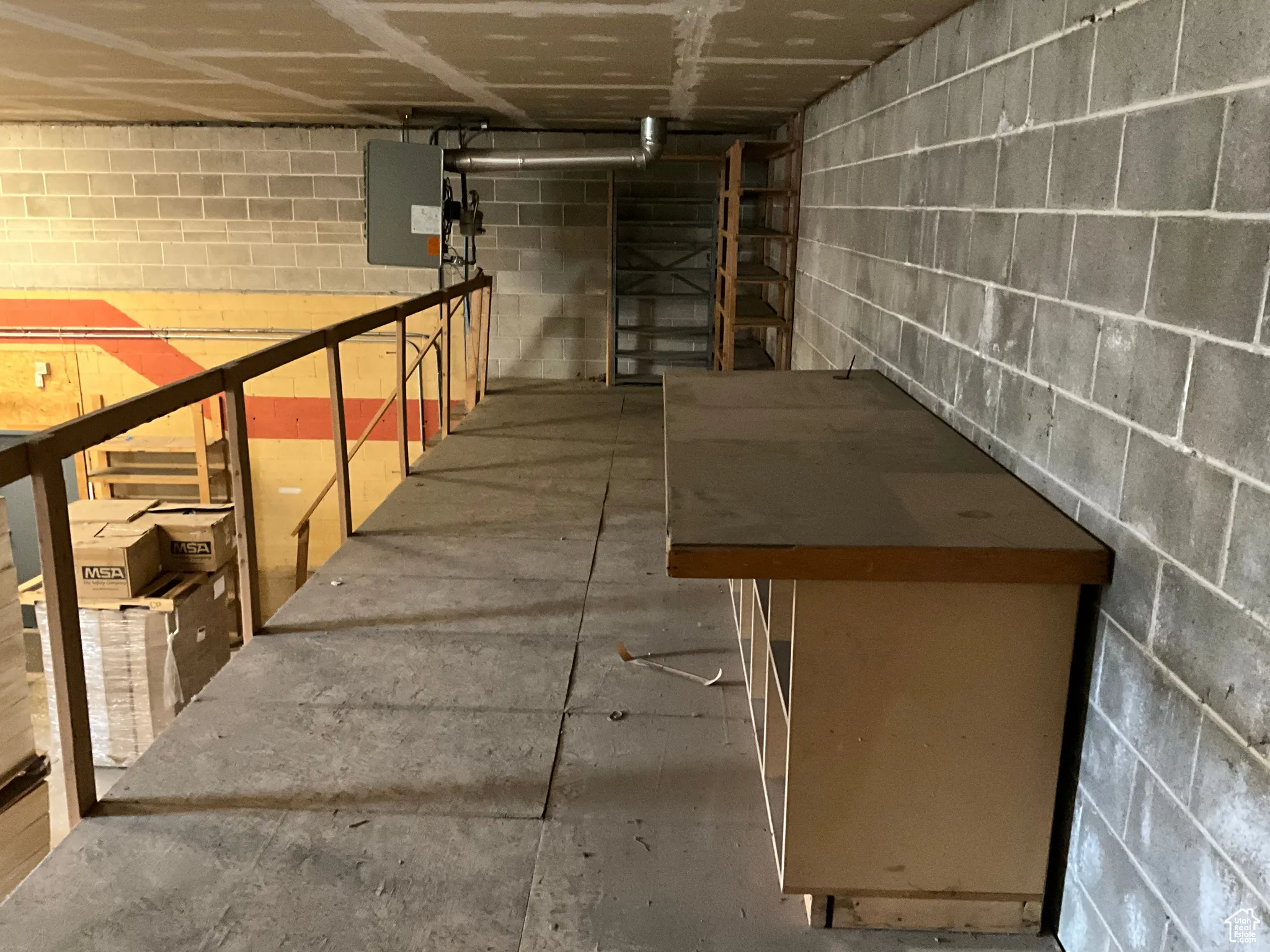 Unfinished below grade area featuring concrete block wall