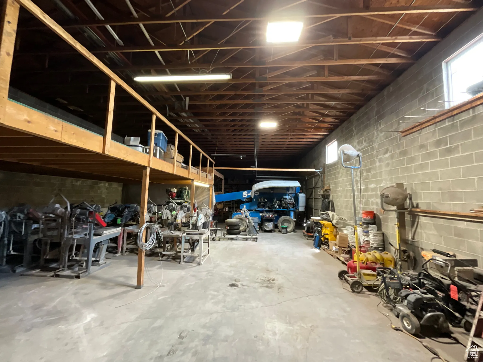 Garage featuring concrete block wall
