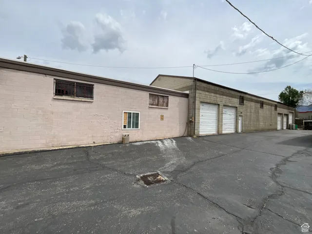 View of property exterior featuring concrete block siding