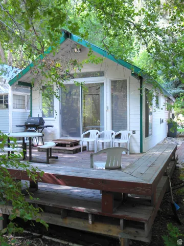 Wooden deck featuring area for grilling