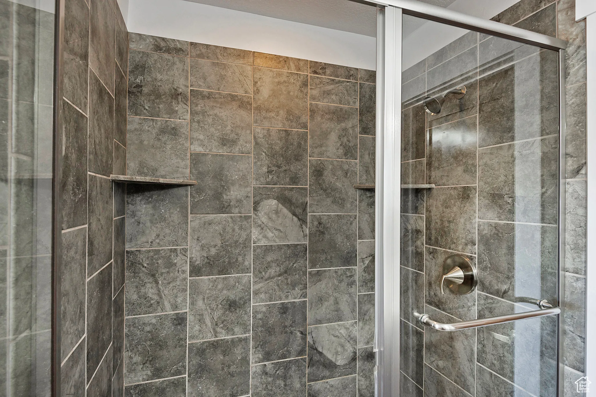 Primary bathroom featuring a glass enclosed stall shower