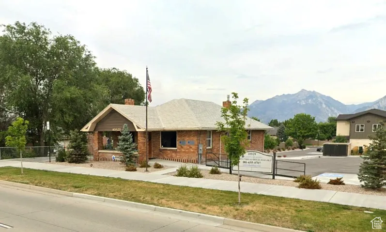 Ranch-style house with a chimney, a mountain view, and brick siding