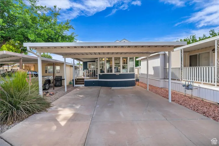 View of patio with a detached carport