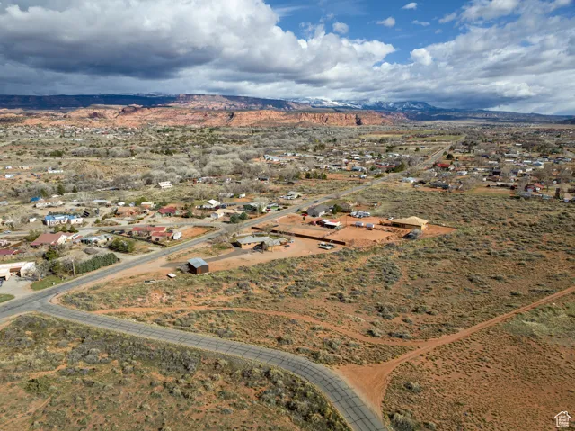 Aerial overview of property's location featuring a mountain backdrop and rural landscape