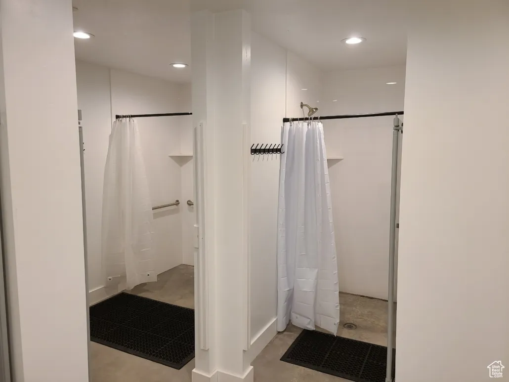 Full bathroom with a shower with shower curtain, recessed lighting, and concrete flooring