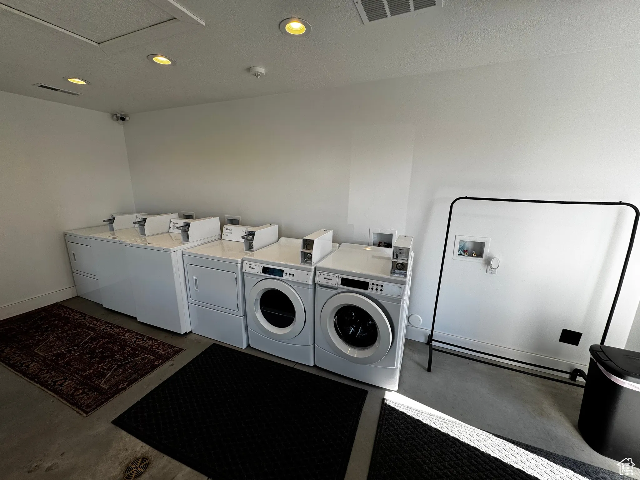 Shared laundry featuring washing machine and dryer, recessed lighting, and baseboards