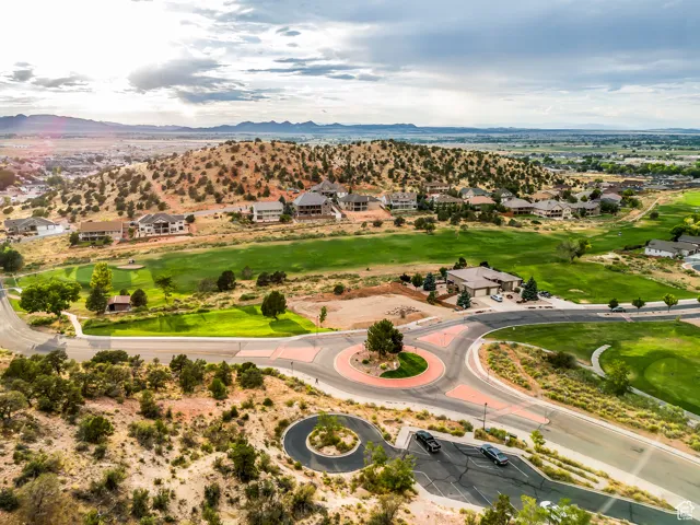 Aerial view of residential area with mountains and a golf club