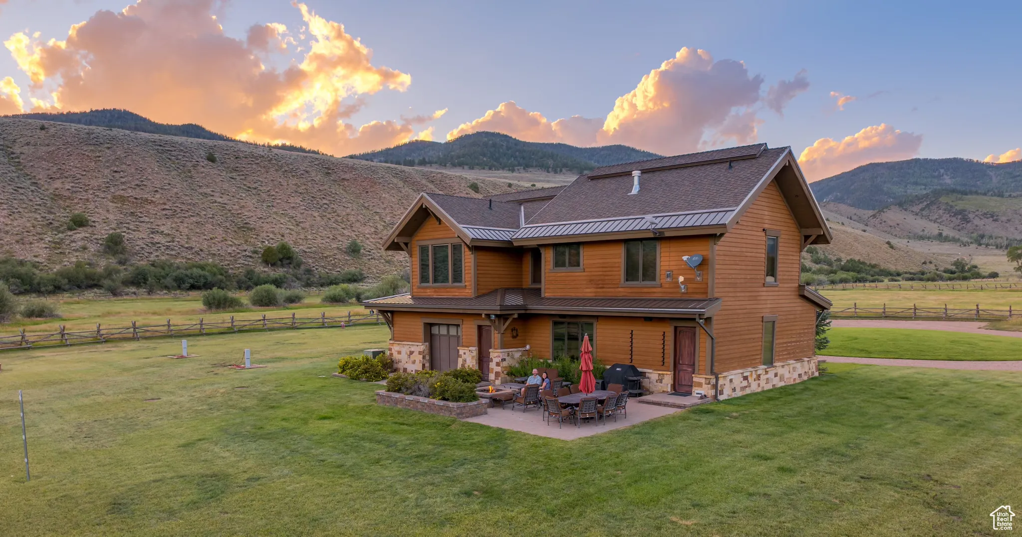 Rear view of house featuring a patio, gas fireplace, and a mountain view