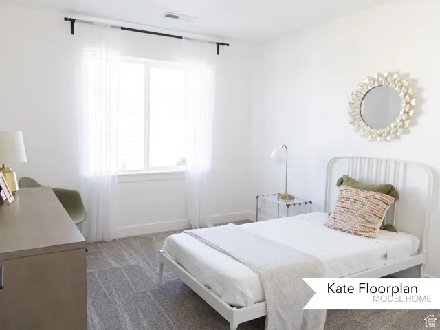 Bedroom with carpet, multiple windows, and baseboards