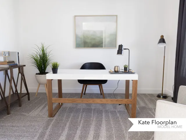 Carpeted office with baseboards