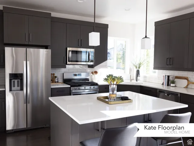 Kitchen featuring stainless steel appliances, a breakfast bar area, tasteful backsplash, and recessed lighting
