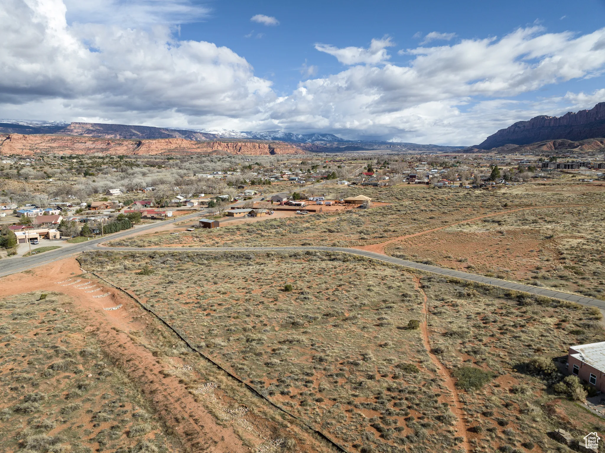 Aerial view of sparsely populated area with a mountain backdrop and a desert landscape