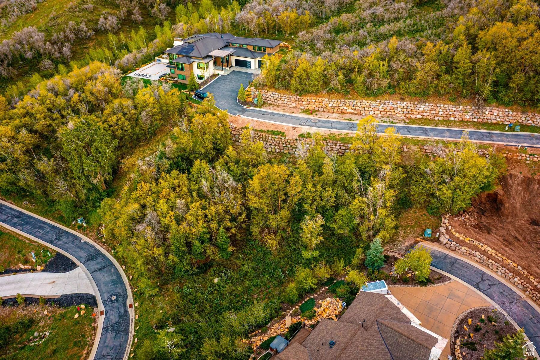 Aerial view of property's location with a forest