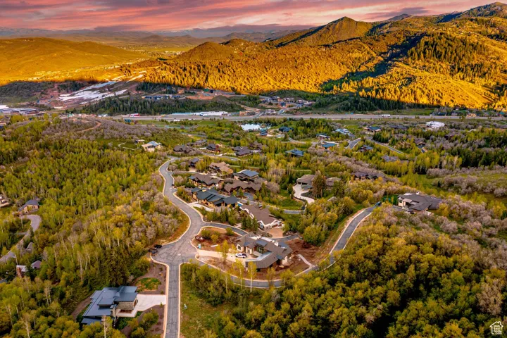 Aerial view of property's location featuring a mountainous background