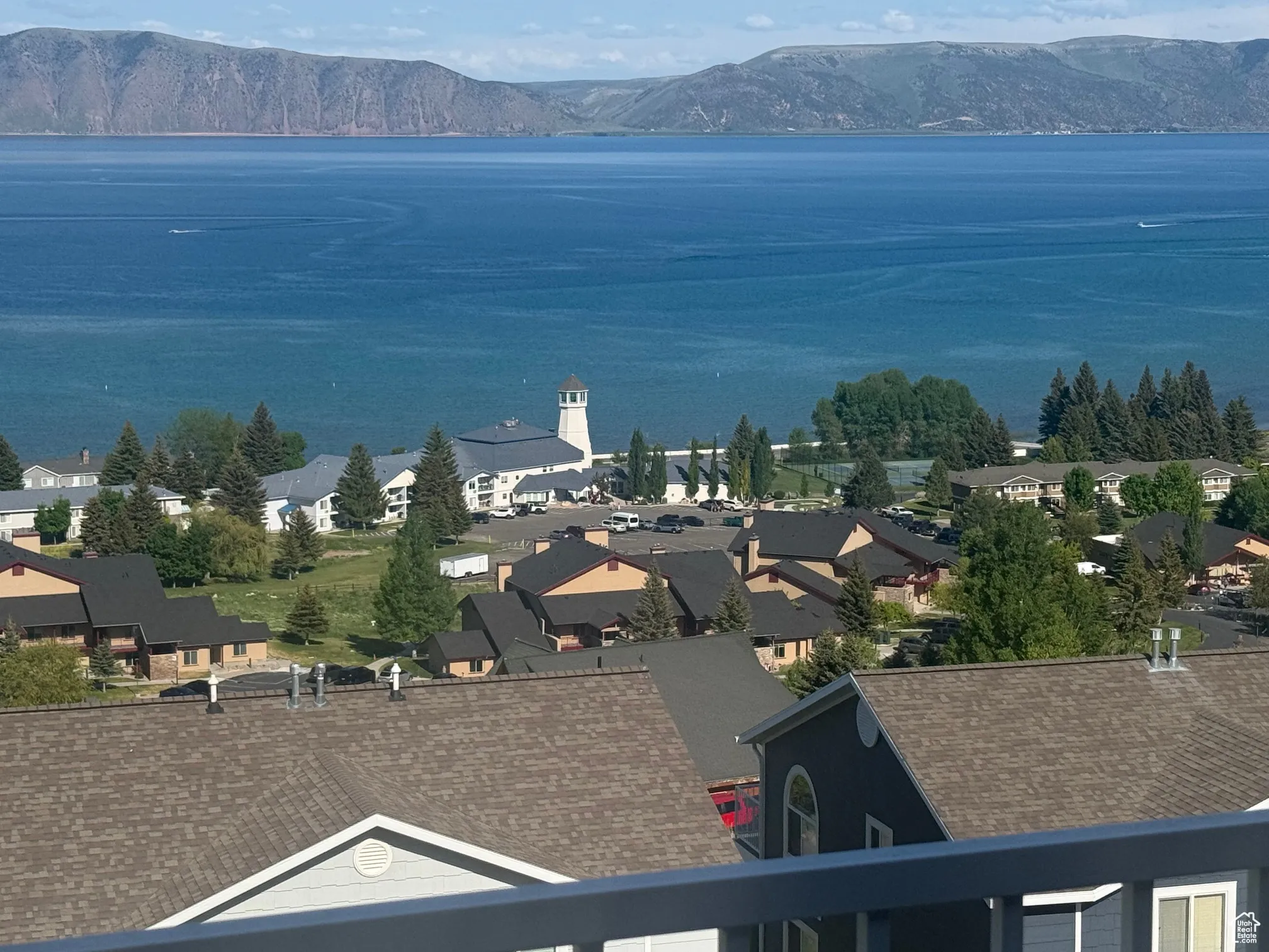 Water view featuring a mountainous background and nearby suburban area