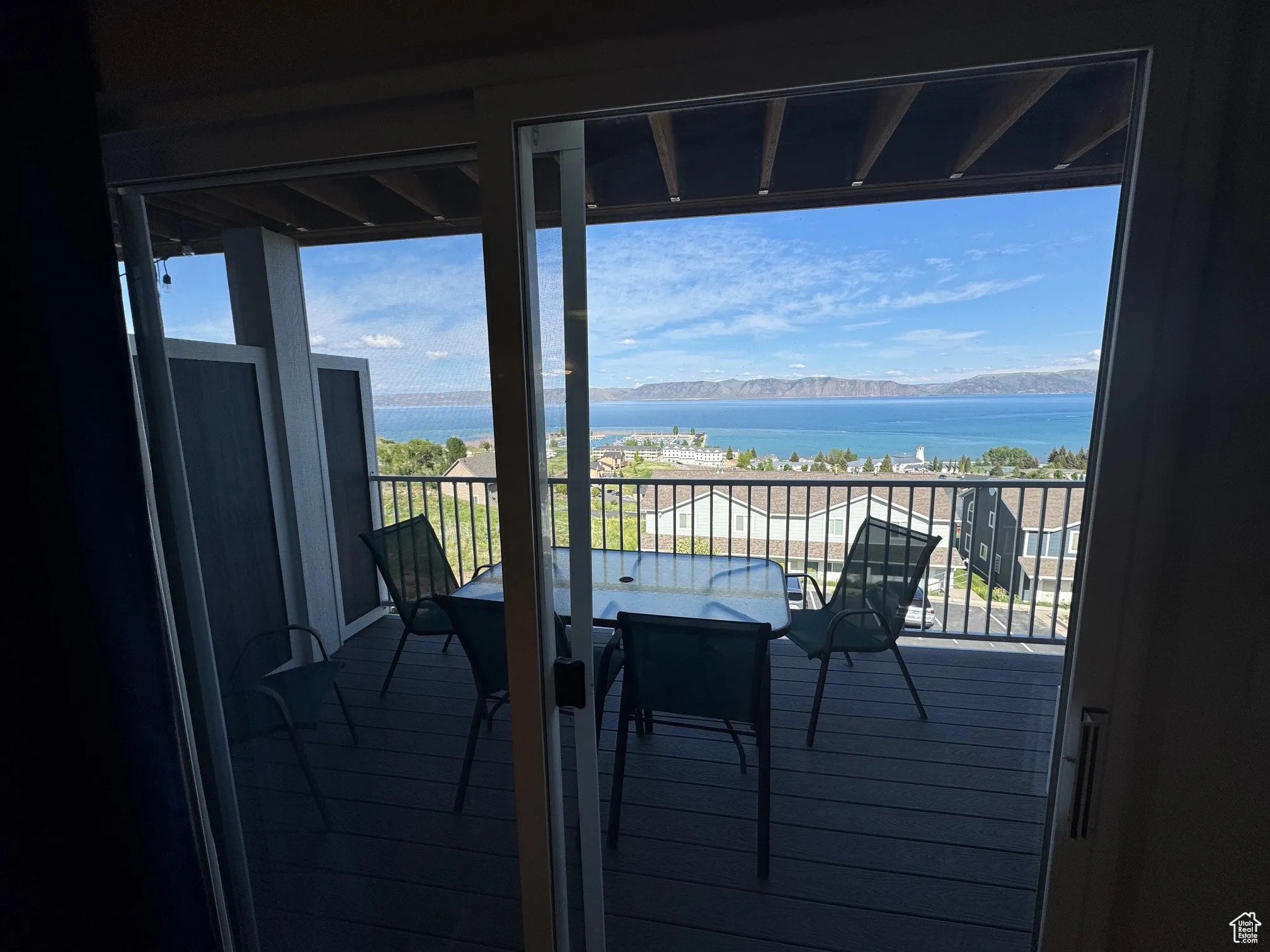 Balcony with a water view and outdoor dining area