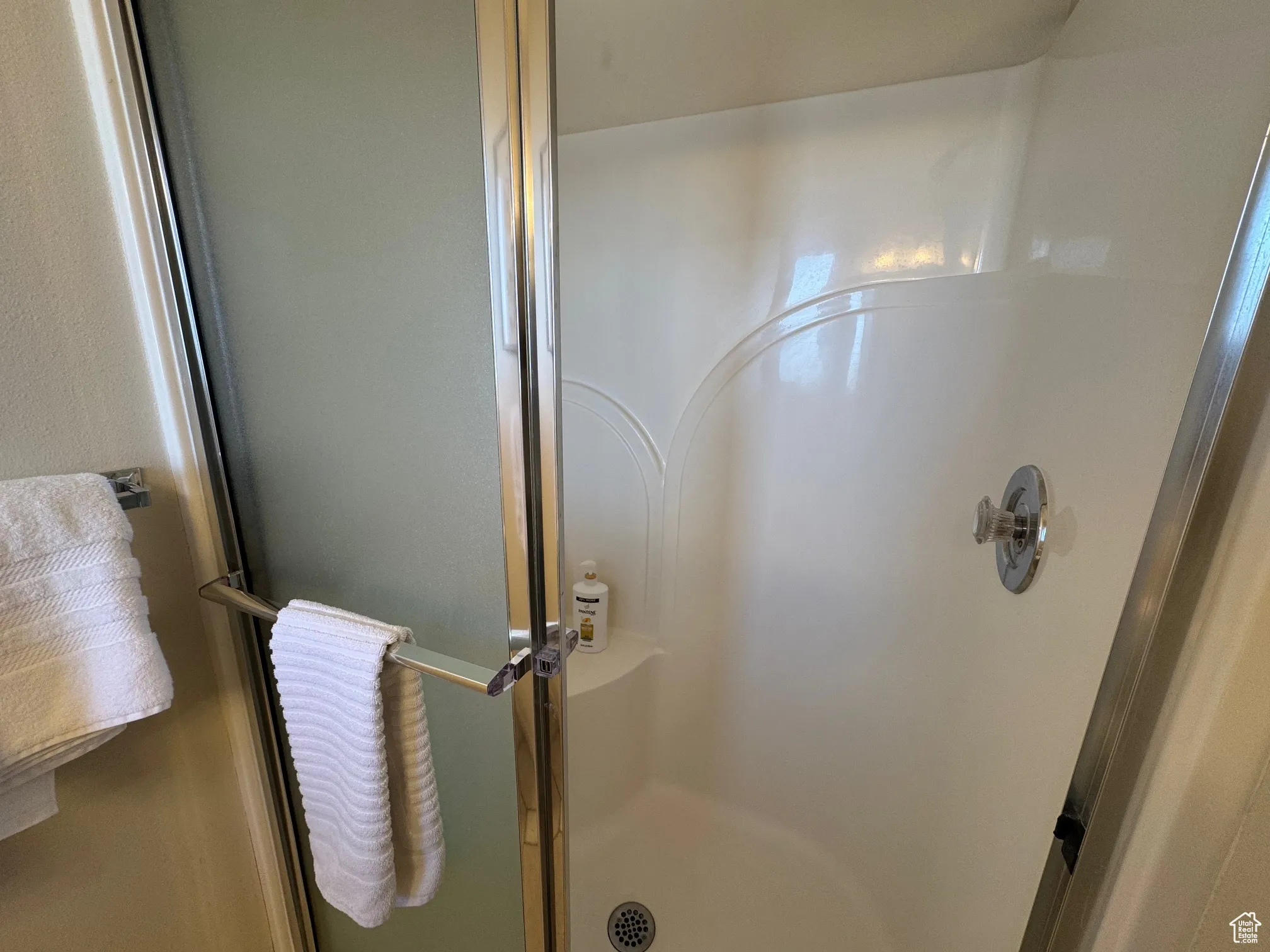 Full bath featuring a shower stall