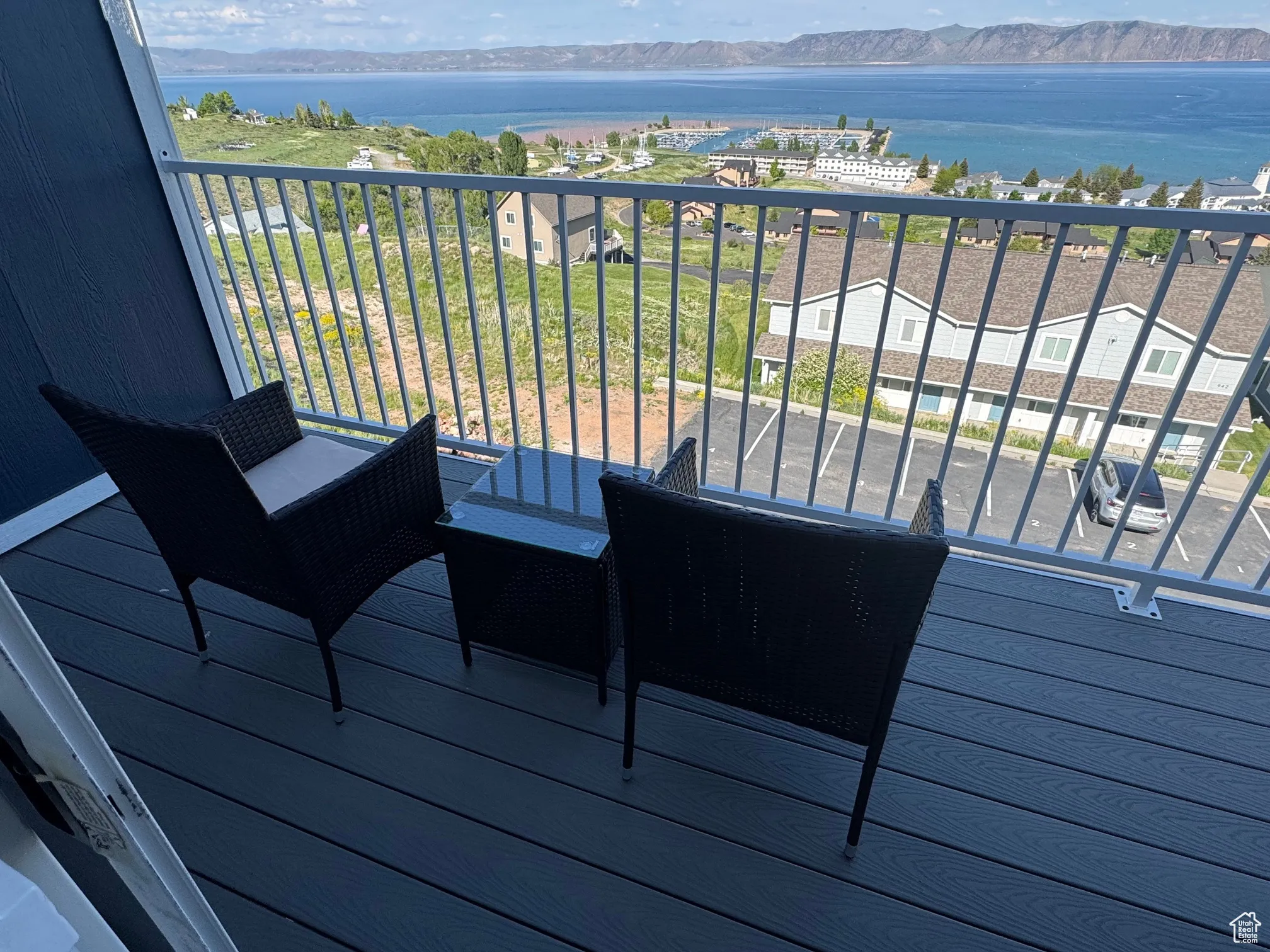 Wooden terrace featuring a water and mountain view