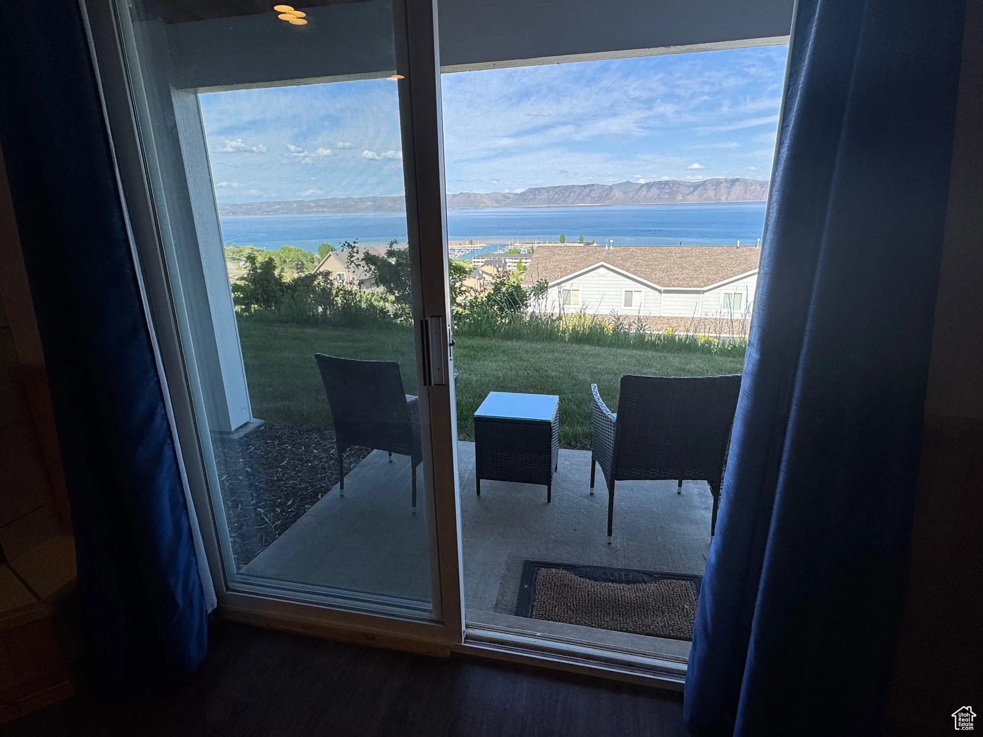 Doorway featuring a water and mountain view and wood finished floors