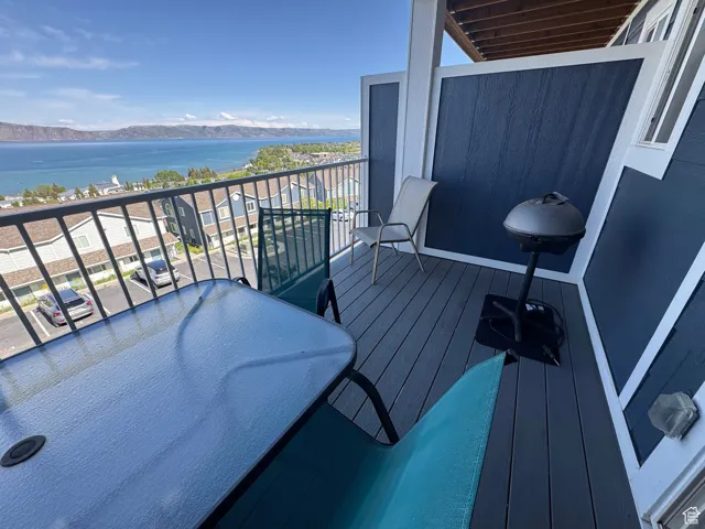 Balcony with a water and mountain view