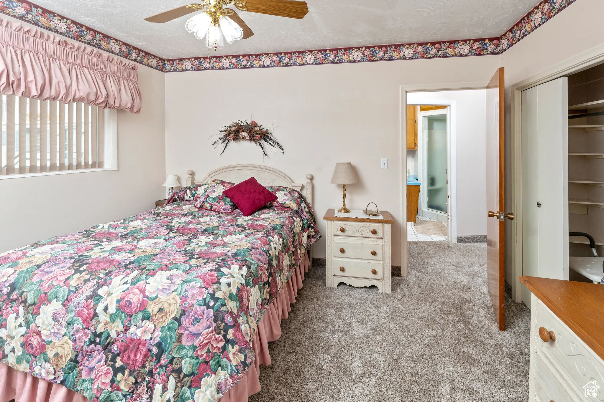 Bedroom featuring carpet floors, a closet, and a ceiling fan