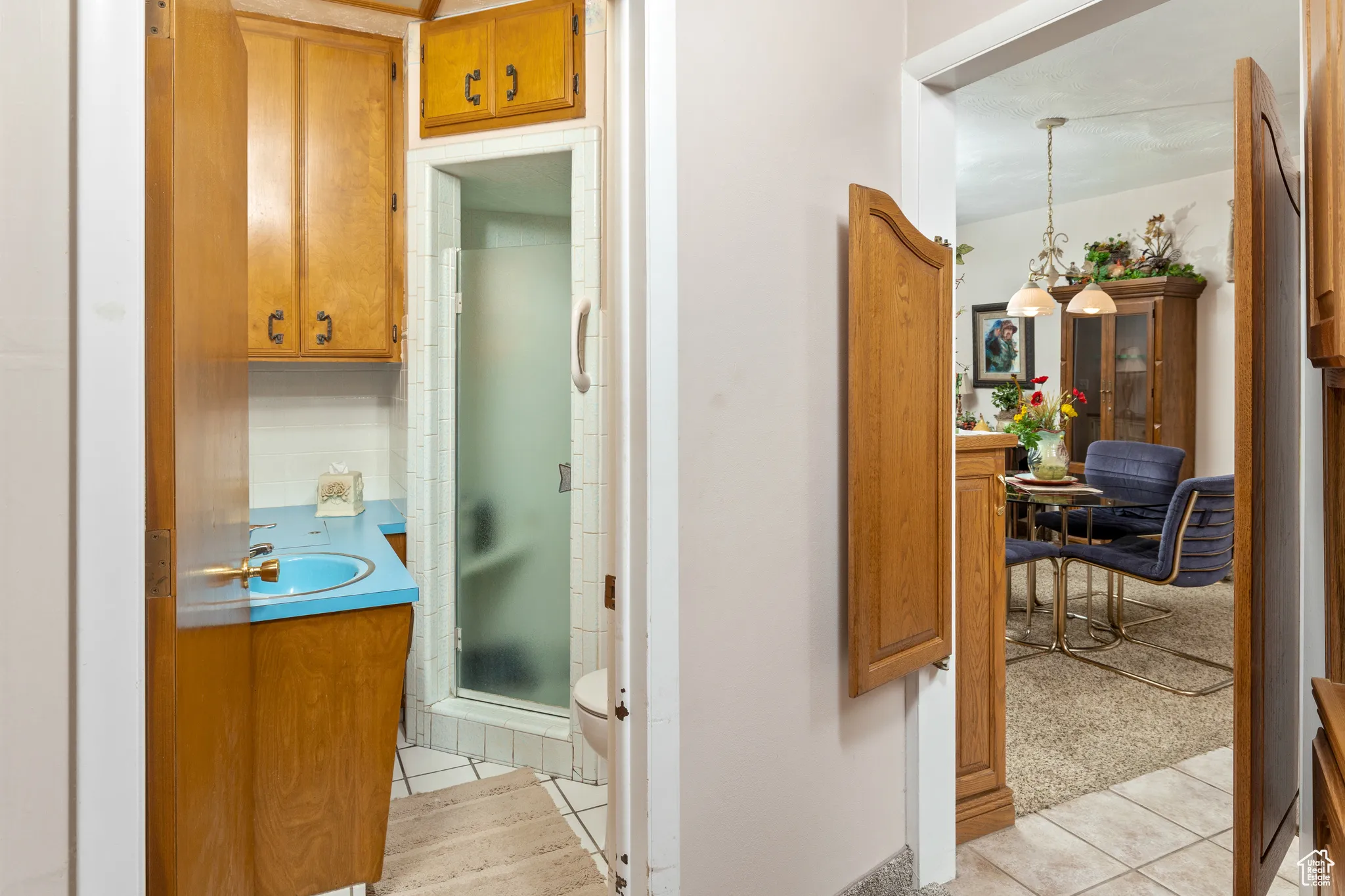 Hall with a sink and light tile patterned floors