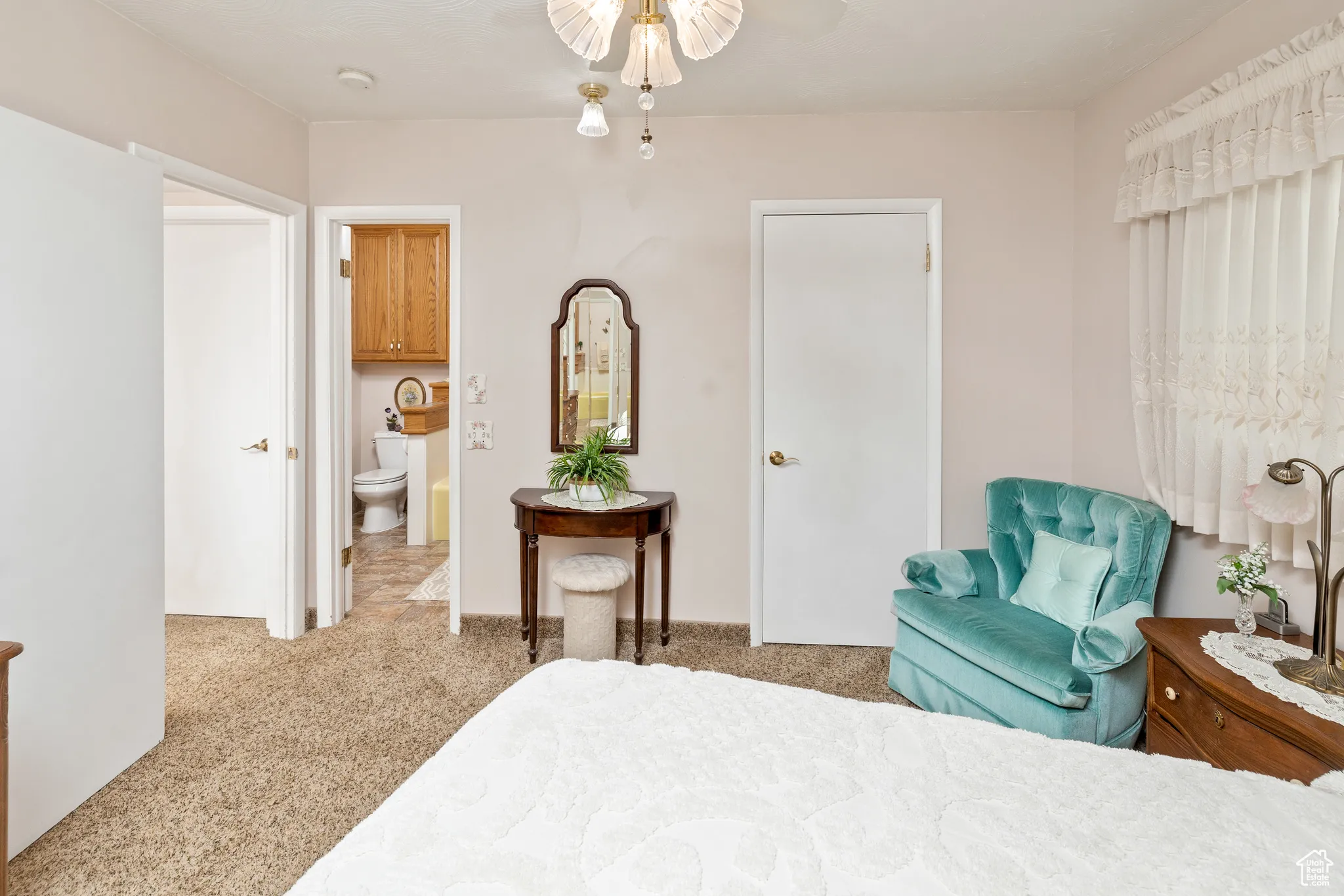 Bedroom with carpet floors and connected bathroom