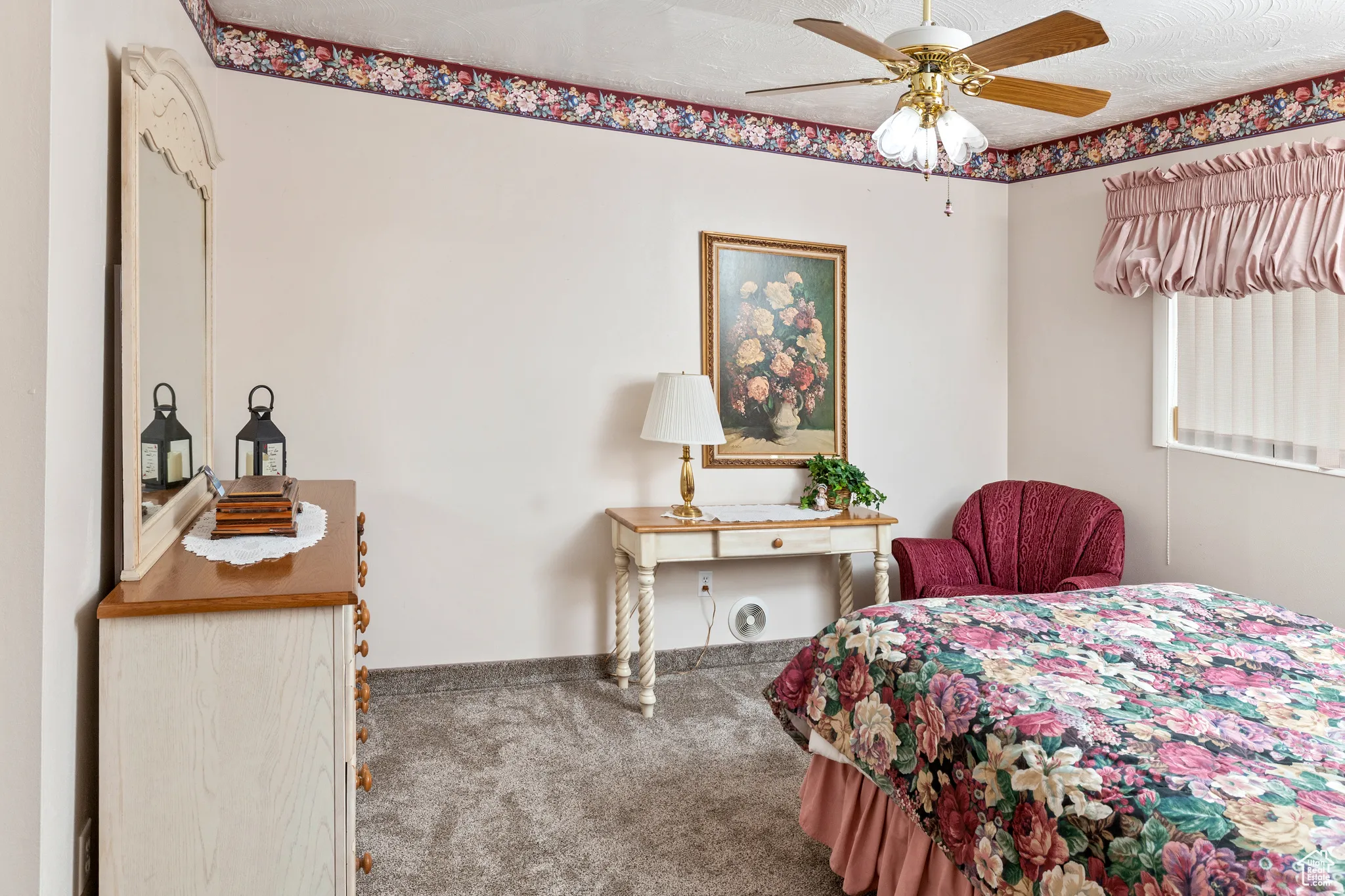 Carpeted bedroom featuring ceiling fan