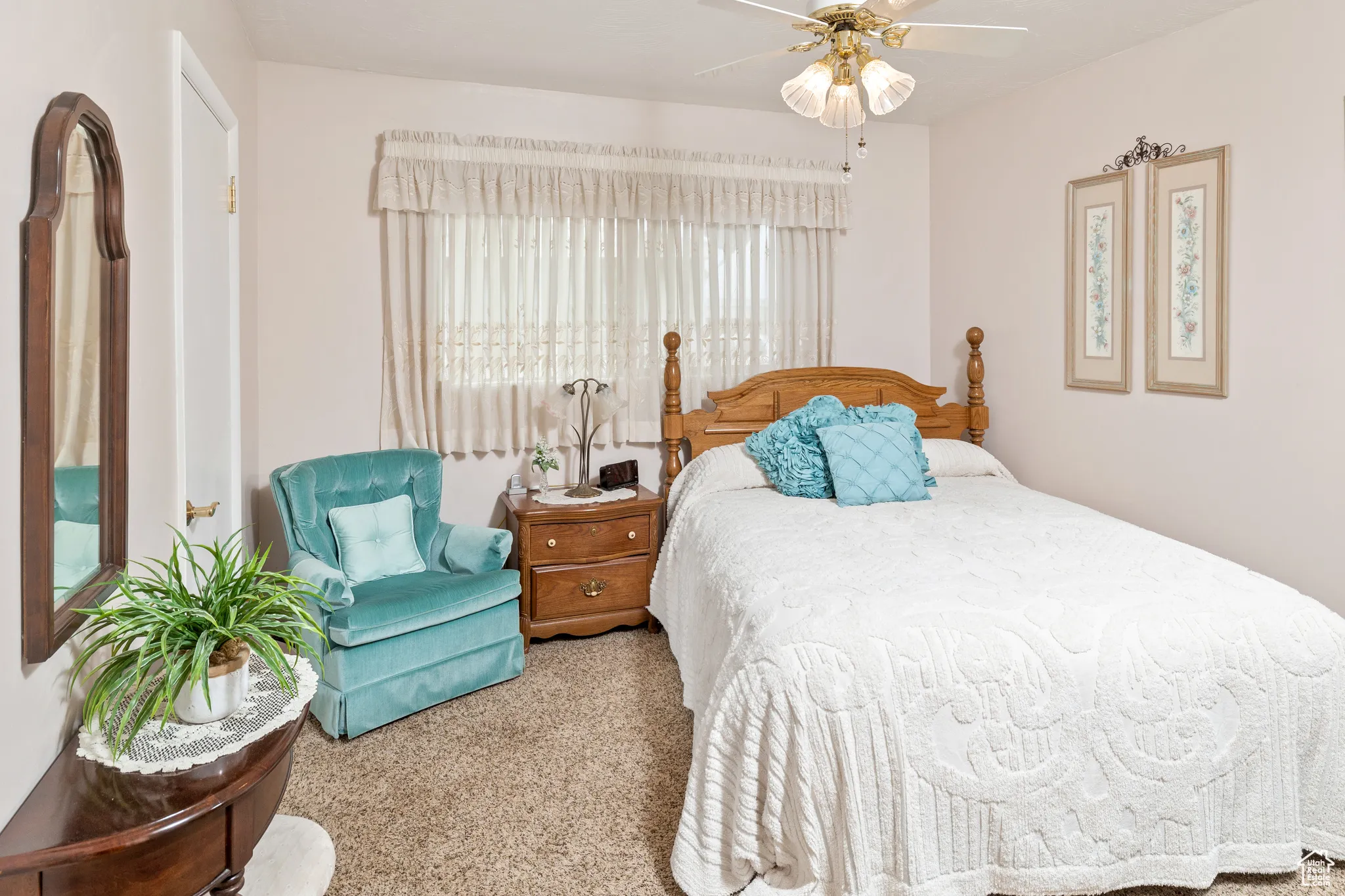 Carpeted bedroom featuring a ceiling fan