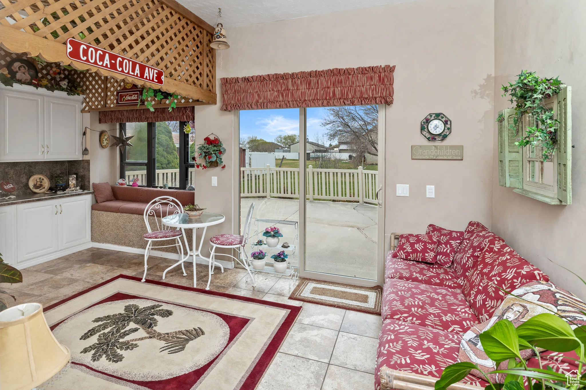 Living room with light tile patterned floors and a high ceiling
