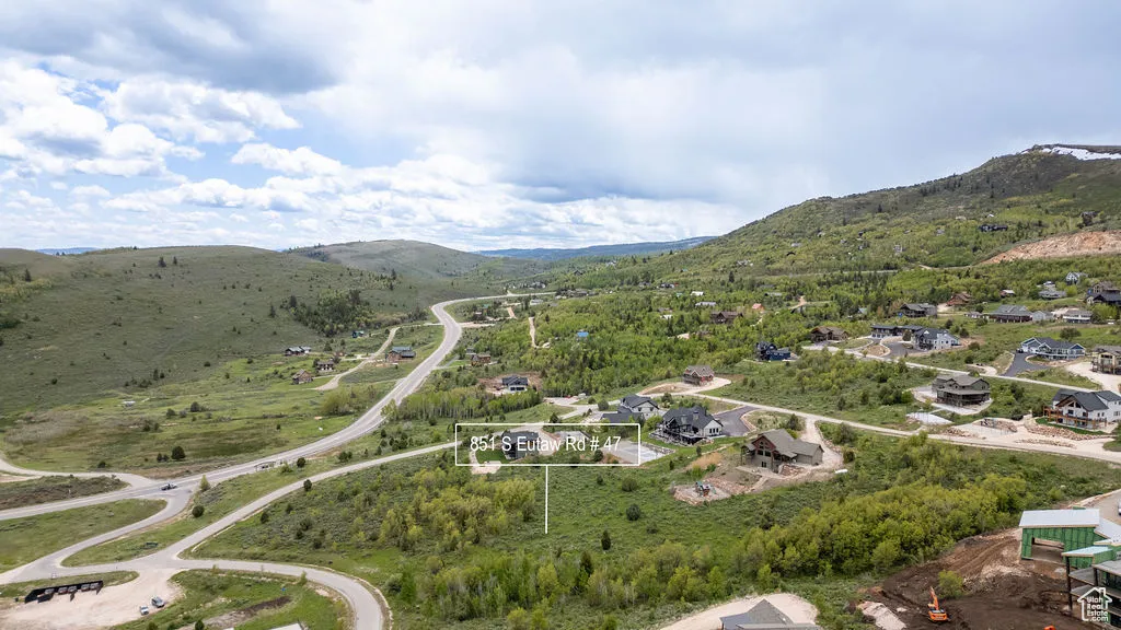 Aerial view of property and surrounding area featuring mountains