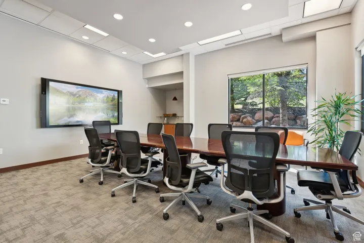 Carpeted office space with baseboards