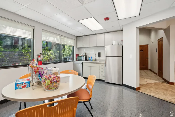 Dining area with baseboards and a drop ceiling