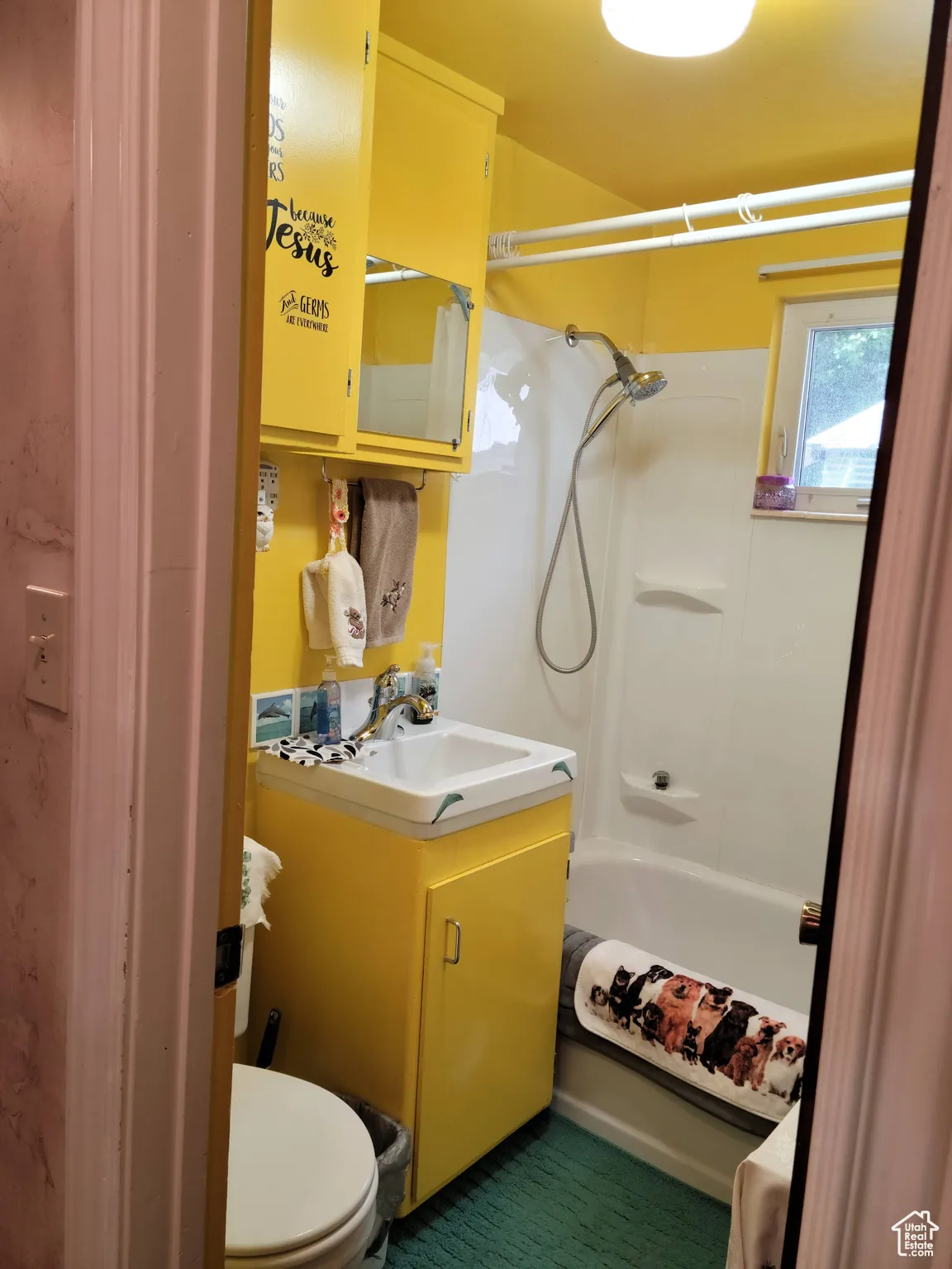 Full bathroom with toilet, vanity, and shower / washtub combination