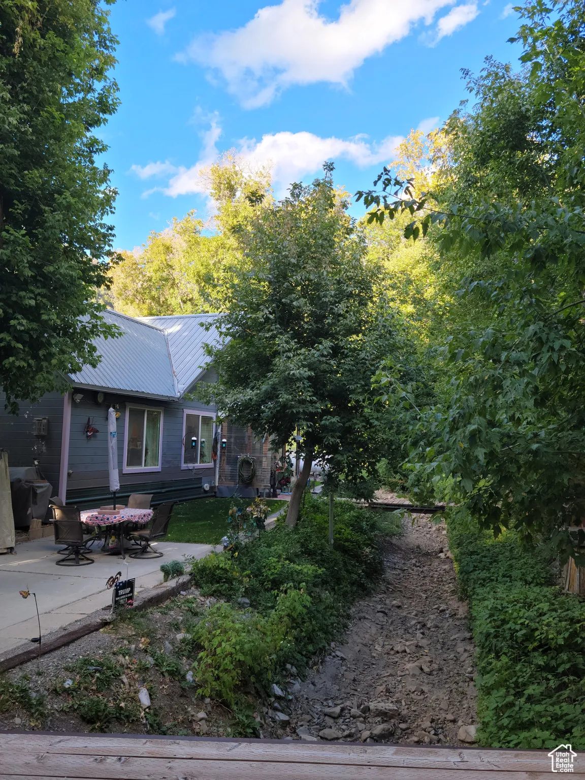 View of rear of home featuring a patio area and metal roof