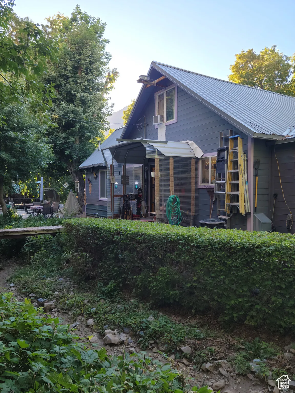Rear view of property with metal roof