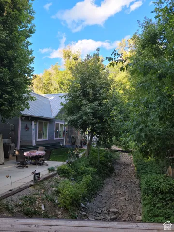 View of rear of home featuring a patio area and metal roof