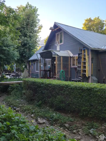 Rear view of property with metal roof