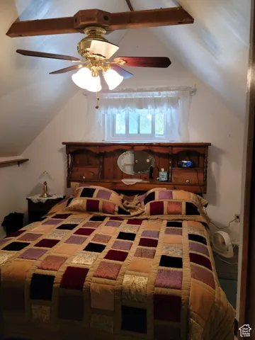 Bedroom featuring vaulted ceiling
