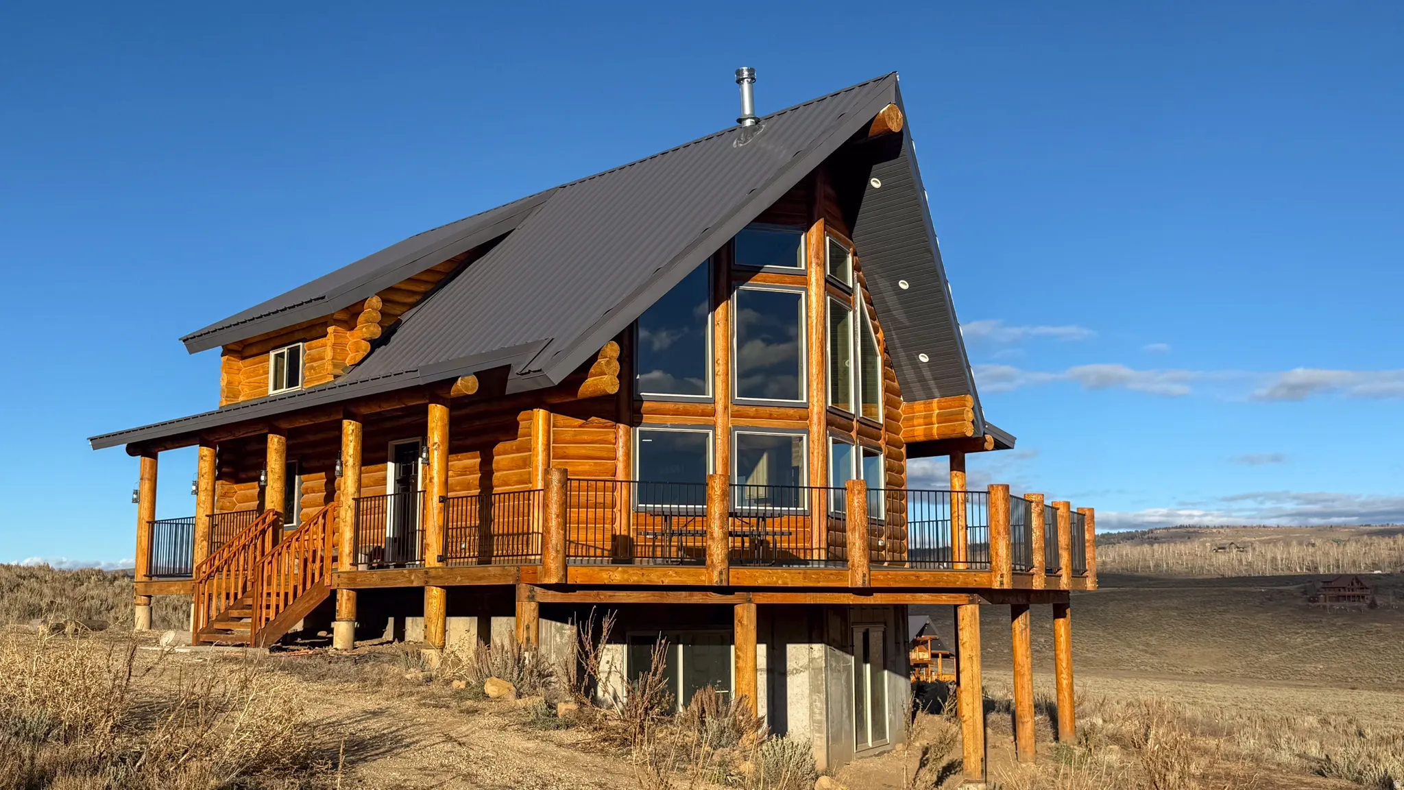 Rear view of house featuring a metal roof and a porch