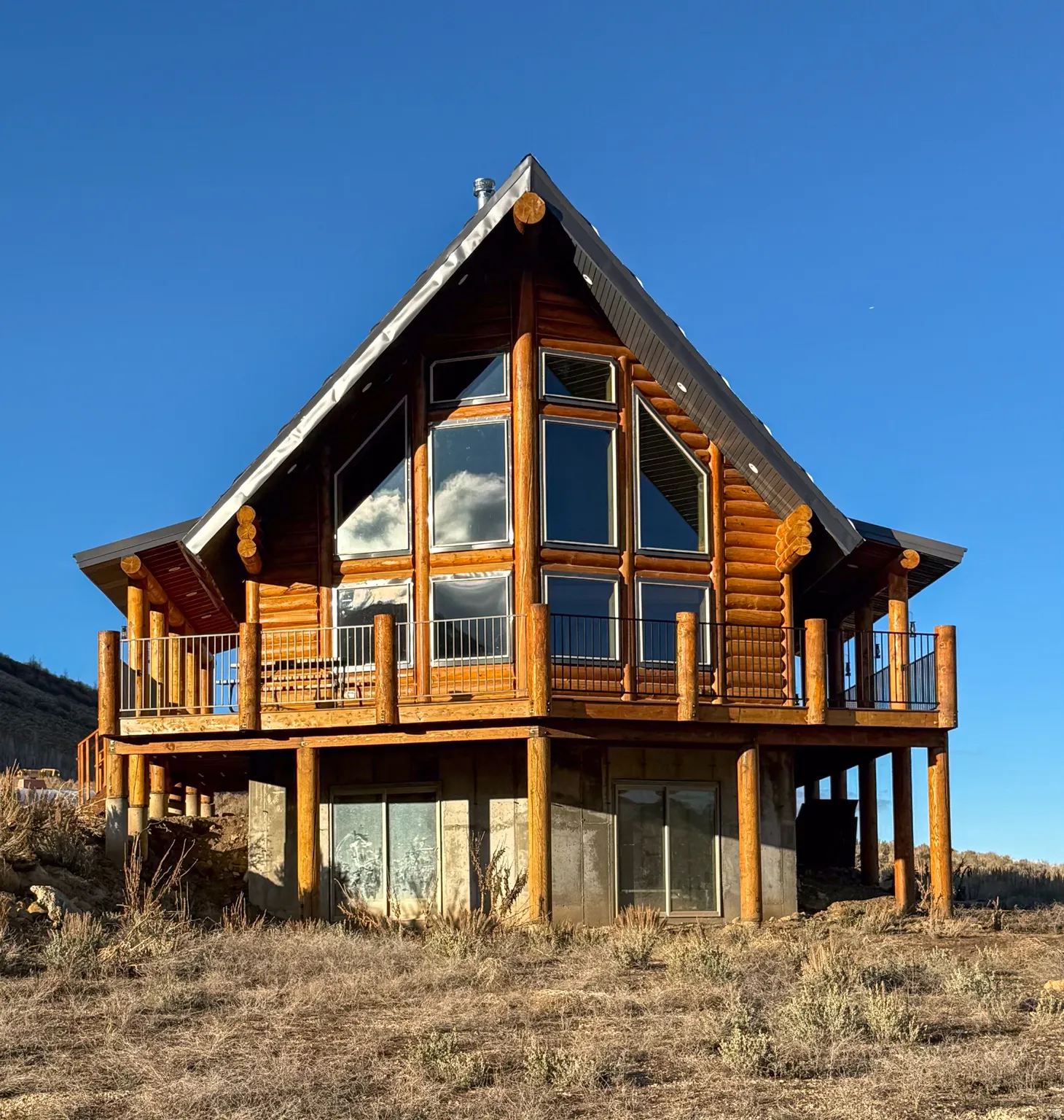 View of side of home featuring a wooden deck and log siding