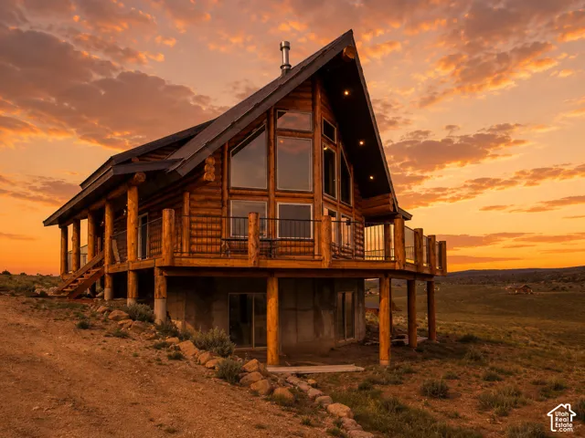 Log cabin residence featuring a steep-pitched roofline and expansive windows