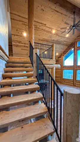 Stairway featuring log walls, wood ceiling, recessed lighting, a ceiling fan, and high vaulted ceiling