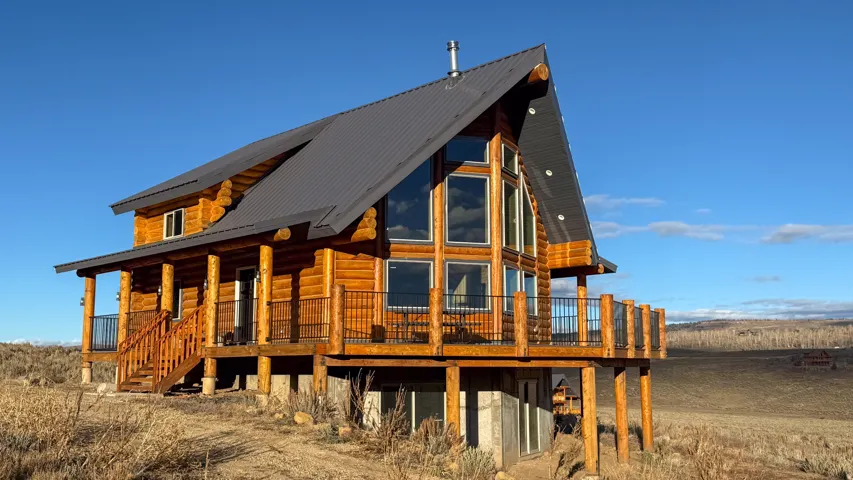 Rear view of house featuring a metal roof and a porch