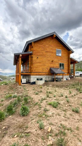 Rear view of property with log exterior
