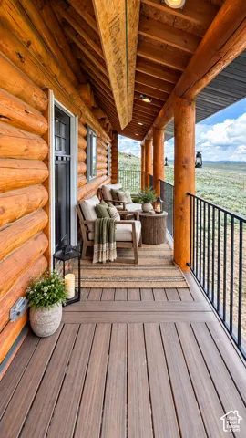 Expansive covered deck featuring wood-finish decking, log-style columns, and a black metal railing