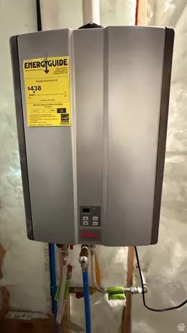Utility room featuring tankless water heater