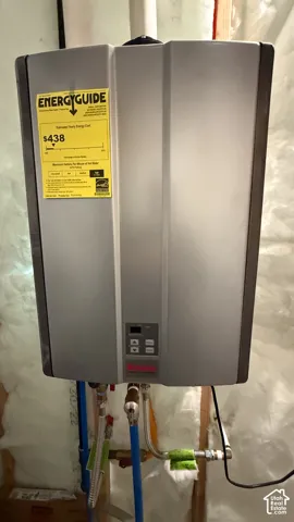 Utility room featuring tankless water heater